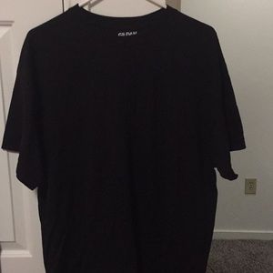 Black shirt with “MUSCLE MILK” on the back